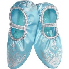 Complete your little one's Frozen costume with a pair of Frozen Elsa Slipper Shoes for girls! These light blue slipper shoes feature metallic silver printed details on top with a metallic elastic band to keep them secure to their feet as they trick-or-treat or dance around. You can a pair these slipper shoes with a matching colored dress (sold separately) to create a DIY Elsa costume. Your child will melt hearts on Halloween while wearing these Frozen shoes! Review the size chart for additional Diy Elsa Costume, Frozen Shoes, Elsa Frozen Costume, Elsa Costume, Blue Slippers, Frozen Costume, Halloween Costume Shop, Halloween Store, Costume Shoes