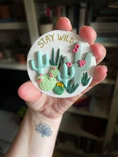 someone is holding up a magnet that says stay wild