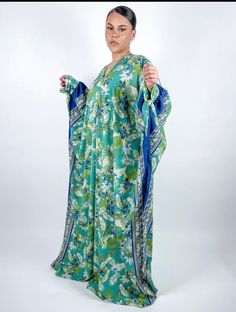 Kaftan made with floral Satin fabric  fabric. Made with floral crepe fabric. Fabric does not stretch.  Polyester  Care Instructions: Machine Wash and Air Dry or Dry Clean only. Green Floral Print Tunic Kaftan, Green Bohemian Kaftan With Floral Print, Blue Floral Print V-neck Kimono, Flowy Floral Print Maxi Kaftan, Green Long Printed Kaftan, Blue Floral Print Flowy Kimono, Blue Floral Print Kimono, Loose Floral Print Beach Dress, Flowy Blue Floral Print Kimono