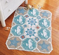 a crocheted doily is laying on the floor next to a dresser