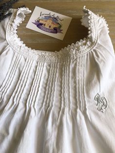 This is a genuine vintage French cotton Childs Nightgown from the 1900's. Made of Quality thick cotton. It could also be worn as a dress, belted or unbelted. This beautiful nightgown carries with it, a lifetime of memories of the French countryside. It is in beautiful condition, no holes, and no real signs of wear. Cool in summer, warm in winter, hardwearing, breathable. Features embroidery on bodice and scalloped edging. IS mongramed with the initials MD. It is buttoned at the shoulders. Size i White Cotton Cottagecore Nightgown, Vintage Cotton Home Dress, Cotton Victorian Dress For Daywear, Vintage Cotton Dress With Historical Design, Classic Cotton Victorian Dress For Daywear, Cotton Victorian Cottagecore Dress For Daywear, Classic Cotton Nightgown For Sleep, Cottagecore Victorian Cotton Dress For Daywear, Victorian Cotton Daywear Dress