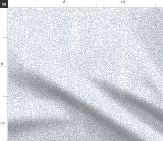 an image of a white and grey animal print fabric with a ruler on the side