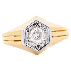 a yellow and white gold ring with a diamond in the center