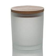 a white glass jar with a wooden lid