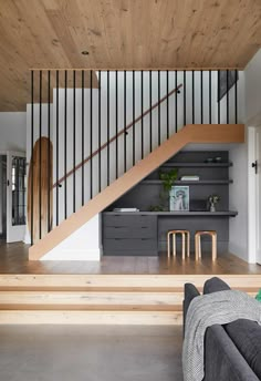 a living room with wooden floors and stairs