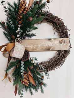 a christmas wreath with pine cones and berries