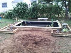 an empty pool in the middle of a yard with trees and bushes around it, surrounded by dirt