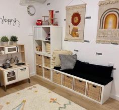 a living room filled with lots of furniture next to a wall mounted oven and microwave