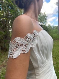 "READ BEFORE PLACING YOUR ORDER: - Buy samples of similar lace here: https://www.etsy.com/listing/190961642/sampleswatch-lace-chiffon-ribbon-or?ga_search_query=sample&ref=shop_items_search_1 - My stock is very limited and the order are made after they are placed. - THIS IS A CUSTOM ORDER I don't accept returns. - Read the reviews. You bought your dream dress but it doesn't have straps! No problem. I can made them for you. I'll try my best to match it as much as possible to your dress so they will look like part of the original design and you will feel happier with the result! Beautiful off the shoulder straps made of embroidered rayon ivory color lace. 3\" widest part. Length is 17\"  It will have one side of the snaps attach to both ends and the other side for you to attach to your dress Silver Fitted Bridal Accessories, Fitted Lace Bridal Belt For Bride, Fitted Lace Bridal Belt For Ceremony, Fitted Lace Trim Bridal Accessories For Bride, Fitted Lace Bridal Accessories For Bride, Fitted White Lace Bridal Belt, White Fitted Lace Bridal Belt, Lace Bridal Accessories Fitted For Mother Of The Bride, Fitted Lace Bridal Accessories For Mother Of The Bride