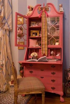 a pink desk and chair in a room