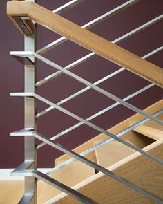 a close up view of the metal railings on a stair case with wood handrails