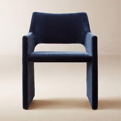 a blue chair sitting on top of a beige floor