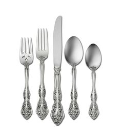 an assortment of silverware including forks, knives and spoons on a white background