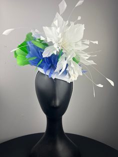 A white button base with a white feather crown, with bold lime green and periwinkle feathers, finished with pretty white vintage velvet flowers. Sits on a comfortable white headband. Lightweight and easy to wear. Ships in a high quality storage box. One of a kind.  Perfect for Kentucky Derby, Royal Ascot, church, weddings, just for fun. Whimsical White Headband Headpiece, Whimsical White Headband, White Fascinator For Spring Races, Spring White Fascinator For Races, White Spring Races Fascinator, White Mini Hats For Spring Races, White Ostrich Feather Wedding Headpiece, White Feather Trim Fascinator For Party, White Hats With Handmade Flowers For Royal Ascot