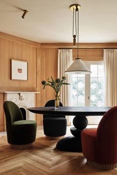 an elegant dining room with wood paneled walls and flooring is furnished with modern furniture