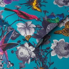 a blue floral print fabric with birds and flowers on the side, as well as butterflies