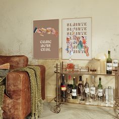 a living room filled with lots of bottles and glasses on top of a metal shelf