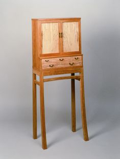 a wooden desk with two drawers on it