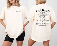 the back and side of a woman's t - shirt that says, the beach club