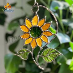 a sunflower is hanging from a tree branch with green leaves on the bottom and yellow petals