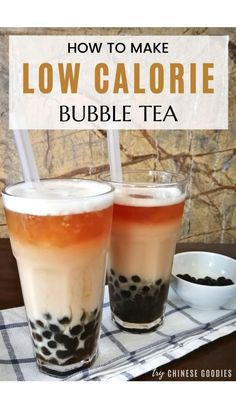 two glasses filled with bubble tea sitting on top of a table