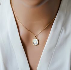 This stunning Mother of Pearl necklace is perfect for any situation - dress it up or down! Handcrafted with 24k gold electroplate lining the shell's edges, this necklace hangs from a 14k gold filled chain. With its sophisticated and timeless design, it's the ideal accessory for a wedding, special event, or the everyday outfit. Mother of Pearl Meaning: Mother of pearl is believed to have calming, protecting energies reminiscent of motherly love. It's said to sooth tension, while promoting relaxation for the body and spirit. Stone Size: Average .75 to 1" (19 to 24mm) Matching earrings are here. Gold Pendant Shell Necklace With Adjustable Chain, Elegant Gold Plated Shell Necklace As Gift, Gold Pendant Shell Necklace As Gift, Elegant Gold Shell Necklace With Pearl Pendant, Gold Shell Necklace With Pearl Pendant As Gift, Gold Shell Necklace With Delicate Chain For Gifts, Gold Shell Necklace With Delicate Chain As Gift, Elegant Gold Shell Necklace, Delicate Gold Shell Necklace As A Gift