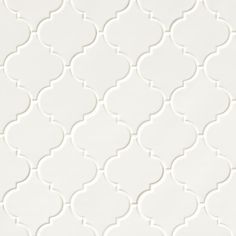 a white wall with an intricate pattern on it