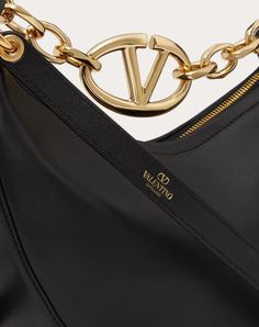 Valentino Garavani VLogo Moon Mini Hobo Bag in nappa leather featuring chain with metallic VLogo Signature element. The bag can be worn as a crossbody bag or handbag thanks to the chain and removable leather shoulder strap. - Gold-finish chain and hardware - Removable leather shoulder strap - Zip closure - Nappa leather lining. Interior: one slip pocket - Shoulder strap drop length: 58 cm / 22.8 in. - Chain drop length: 12.5 cm / 4.9 in. - Dimensions: W20xH23xD8 cm / W7.9xH9.1xD3.1 in. - Made in Luxury Evening Hobo Bag With Branded Hardware, Luxury Hobo Bag With Branded Hardware For Evening, Luxury Hobo Bag With Branded Hardware, Luxury Hobo Bag With Chain Strap For Formal Occasions, Luxury Formal Hobo Bag With Chain Strap, Luxury Gold Hobo Bag, Luxury Hobo Shoulder Bag With Chain Strap, Luxury Hobo Bag With Gold-tone Hardware For Evening, Luxury Evening Hobo Bag With Gold-tone Hardware