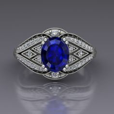 "A beautiful large oval blue sapphire is set in the center of this vintage style cocktail ring in 14k white gold with diamonds. The sapphire is set with double prongs and set off by diamond panels edges with cutouts. Vintage style milgrain beading lines the edges. The ring has a European shank to help stabilize it and the top measures about 13mm at the widest point. Blue Sapphire Dimensions9x7mm EnhancementHeated Carat Weight 2.6 ColorMedium to medium dark navy blue ClaritySlightly included CutGood PolishGood Diamonds Number40 EnhancementNatural Carat Total Weight0.31 ColorF-G ClaritySI1-2 CutVery Good PolishVery Good This is a custom made item! When you order, we will create a wax model of your ring with our 3D printer. This model is then cast in 14k gold, which is polished and set by han Clover Ring, Dream Engagement Rings, Emerald Engagement, September Birthstone, Blue Sapphire Rings, Pretty Rings, Sapphire Jewelry, Best Diamond, Favorite Rings