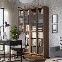 a room with a desk, chair and bookcase