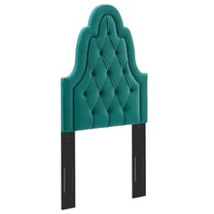 an upholstered headboard with black legs and a turquoise tufted backrest