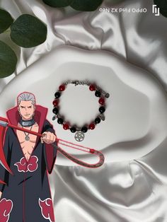 Embrace the mysterious aura and fearsome style of Hidan from Naruto Shippuden with this unique bracelet. Designed for true fans of the Naruto universe, this handmade jewelry is perfect for expressing your passion while adding a touch of originality to your look. Materials: Black and red beads, reflecting the dark and menacing colors associated with Hidan ⚫🔴. Charms: Adorned with a pentagram-shaped charm and skull-shaped charms, symbolizing Hidan's iconic power and his affiliation with Akatsuki Adjustable Fantasy Bracelets As Gift, Handmade Symbolic Black Bracelets, Handmade Symbolic Black Beaded Bracelets, Adjustable Red Fantasy Jewelry, Customized Black Themed Jewelry, Handmade Black Jewelry For Cosplay, Customized Themed Black Jewelry, Unique Adjustable Jewelry For Cosplay, Themed Black Wristband As Gift