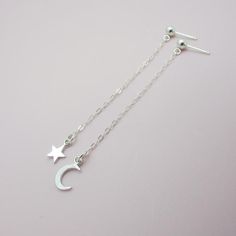 SOLID STERLING SILVER EARRINGSThese celestial earrings make a wonderful gift. The real sterling ear studs are adorned with a tiny moon and a tiny star that dangle elegantly on sterling silver chain. Comes in a gift box, perfect for gift giving. Total earring length is approximately 2 3/4 inches long.ALSO AVAILABLE IN AN ALL MOON DESIGN OR ALL STAR DESIGN Celestial Silver Earrings With Star Charm, Celestial Sterling Silver Drop Earrings, Sterling Silver Celestial Earrings For Gift, Sterling Silver Celestial Drop Earrings, Dainty Moon-shaped Sterling Silver Earrings, Sterling Silver Earrings With Star Charm, Dainty Sterling Silver Star Earrings, Moon Charm Star-shaped Earrings For Gifts, Moon Charm Star Earrings As Gift