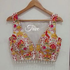 This Made to Order/Made to Measurement/Custom Made Indian Ethnic Blouse. - Fabric - Embroidered Georgette - Color -Red and White - Princess Cut - Rich Lined - Shoulder string with latkans - Sleeveless - Beads around waist - Extra margin and extra stitches included in the blouse - It can be customize in any color, design or size  MEAUREMENTS & CUSTOMIZATIONS This blouse can be purchased in your standard sizing and pattern. Please choose your Chest Size (measured in inches) from the drop-down box. Peacock Blue Lehenga Color Combos, Sleeveless Multicolor Choli With Floral Embroidery, Sleeveless Multicolor Floral Embroidered Choli, Sleeveless Multicolor Floral Embroidery Choli, Bohemian Choli With Floral Embroidery For Spring, Bra Blouse For Saree, Traditional V-neck Choli For Summer, Bohemian Sleeveless Choli With Resham Embroidery, Bohemian Sleeveless Choli With Intricate Embroidery