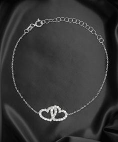 Interlocking Hearts Bracelet:Interlocking hearts celebrate a united love that is destined to last for eternity. This passion and deep connection is captured beautifully in this stunning, yet heartfelt design. This piece is handcrafted by professional jewelers using genuine .925 Sterling Silver. This offers comfortable daily wear thanks to sterling silver’s hypoallergenic properties that prevent skin irritation. A Certificate of Authenticity is included.It’s then triple-plated with rhodium, a luxurious precious metal that’s over 8x more valuable than gold and 700x more valuable than silver because it’s significantly more rare and vibrant. Rhodium is also a stronger metal. Making it resistant to scratches, tarnishing, and corrosion to maintain its gorgeous luster. Glistening AAAA Cubic Zirco Sterling Silver Heart Bracelet, Bonus Dad Gifts, Bff Bracelets, Bracelet Luxury, Goddaughter Gifts, Interlocking Hearts, Silver Heart Bracelet, Step Dad Gifts, Step Mom Gifts