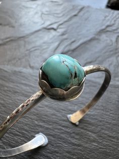 Turquoise and sterling cuff bangle bracelet, bezel set charm silver stacking bracelet, gift for her Featuring a bezel set vintage Tyrone turquoise charm set in sterling silver. The stone sits atop a sterling silver bangle which has been hammered, oxidised and polished. The bracelet is a small 6 - 6.5" wrist.  **Please note this type of bangle fits sideways on to the wrist** You can gently widen the cuff if need be. Wear alone or stacked with other jewellery. **Please note this type of bangle fit Turquoise Charm, Sterling Silver Bangle, Cuff Bangle Bracelet, Sterling Silver Bangles, Silver Bangle, Charm Set, Cuff Bangles, Silver Bangles, Bracelet Stack