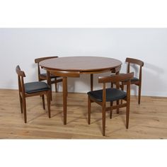 a wooden table with four chairs around it