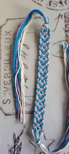 two blue and white beads are laying on a table with some writing in the background