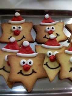 decorated cookies in the shape of stars with santa hats