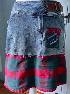 This upcycled super comfy denim skirt has a wide plaid hem, with appliqued adornments to match. It has a decorative snap belt, button, and zipper closing. The waist is about 34" and the length is approximately 18". Denim Patchwork Skirt For Fall, Casual Upcycled Denim Skirt, Fall Denim Patchwork Skirt, Casual Cotton Upcycled Skirt, Casual Cotton Skirt With Upcycled Details, Casual Upcycled Cotton Skirt, Casual Plaid Skirt With Patchwork, Casual Denim Skirt Upcycled, Casual Reworked Medium Wash Denim Skirt