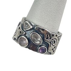 This handcrafted artisan ring is a striking piece of jewelry, ideal for those who appreciate unique, abstract designs. Made from high-quality silver, it features intricate patterns and gemstone inlays that add a touch of elegance. The ring's broad band ensures a comfortable fit, making it a standout addition to any jewelry collection. * Handcrafted artisan design * High-quality silver material * Intricate abstract patterns * Gemstone inlays for added elegance * Broad band for a comfortable fit Some tarnishing on the interior. Size: 6, weighs 7.13 g Ring With Gemstone, Artisan Rings, Abstract Designs, Artisan Design, Silver Material, Intricate Patterns, Rings Statement, Abstract Pattern, Sterling Silver Ring