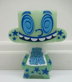 a green and blue figurine with stars on it