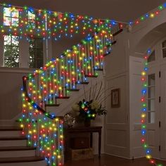 a staircase decorated with multicolored christmas lights