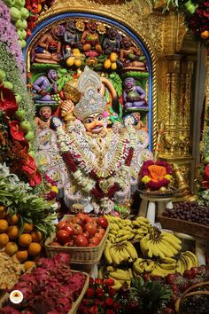 there are many fruits and vegetables on display in the room, including bananas, apples, oranges, grapes, and other things