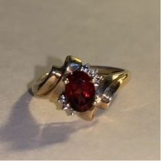 This beautiful vintage art nouveau ring is the perfect gift for Mom, Wife, Sister, Girlfriend or Daughter. The 10K gold rings holds an oval garnet with tiny diamond look chips on either side.  Features: 10K Gold Vintage pre-owned ring Garnet colored oval stone Diamond type chips - 2 per side January Birthstone Garnets are said to help prevent nightmares This ring would make a wonderful gift for Christmas, Birthday, Valentine's Day or Anniversary.  Free shipping  Returns accepted within 14 days (see policy) Art Nouveau Ring, 10k Gold Ring, Colored Stone Rings, Colored Stone, January Birthstone, Tiny Diamond, Art Nouveau Style, Gold Gift, Red Band