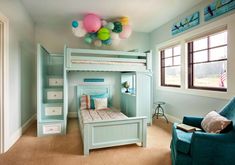 a child's bedroom with a bunk bed and blue chair