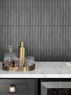 a marble counter top with glasses and bottles on it