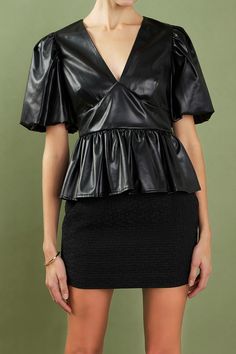 This leather blouson top is the perfect way to add some edge to your style. With its short puff sleeves and peplum hem, this top is sure to turn heads. The stretchy leather ensures a comfortable fit, while the side zipper allows you to easily slip it on and off. Dress it up or down, this top is a wardrobe must-have. Puffy Sleeves Peplum hem V-neckline Side zipper Faux Leather Lined Hand wash cold Do not bleach Do not tumble dry Do not dry clean Do not iron Shell: 50% Polyurethane 47% Polyester 3 Fall Peplum Blouse For Night Out, Chic Black Peplum Top For Night Out, Party Short Sleeve Tops With Ruffle Hem, Chic Fall Peplum Top, Chic Fall Peplum Top With Puff Sleeves, Fitted Black Peplum Top For Night Out, Chic Fitted Black Peplum Top, Fitted Blouse With Ruffle Hem For Night Out, Spring Peplum Top For Night Out