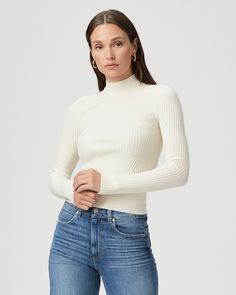 This ivory long sleeve high neck top is made from an incredibly soft and comfortable ribbed knit material with a flattering stitch detail at the waistline. Pair the Raisa Top with any shade of denim in your closet. | Raisa Top - Ivory | Size Large