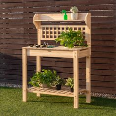 a wooden plant stand with potted plants on it